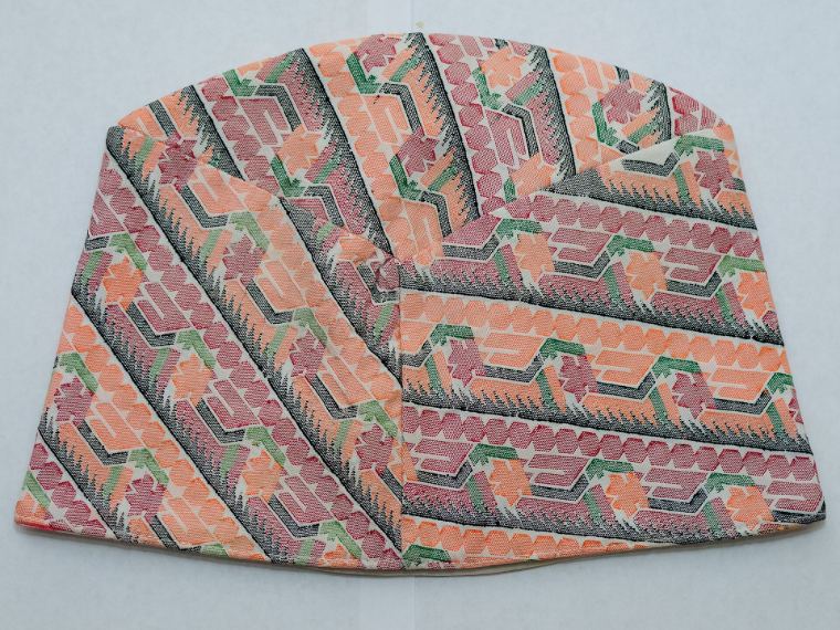 A Palpali dhaka topi with red, black and white geometric weave